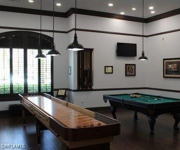 playroom with crown molding, a high ceiling, wood finished floors, and pool table