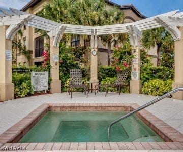 view of pool featuring a patio area, a hot tub, and a pergola