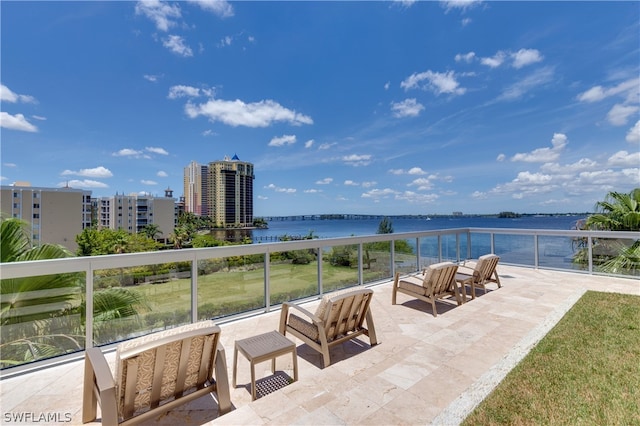 view of terrace with outdoor lounge area, a balcony, and a water view