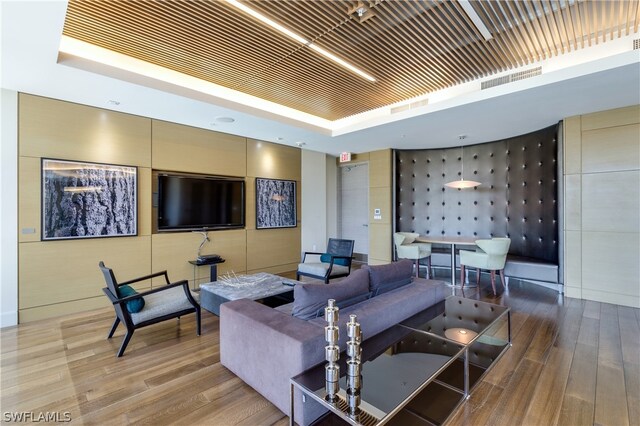 interior space with hardwood / wood-style flooring and a raised ceiling