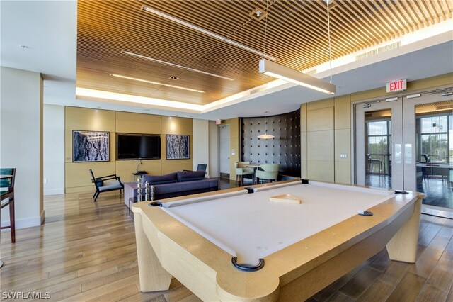 recreation room featuring french doors, a tray ceiling, hardwood / wood-style floors, billiards, and wood ceiling