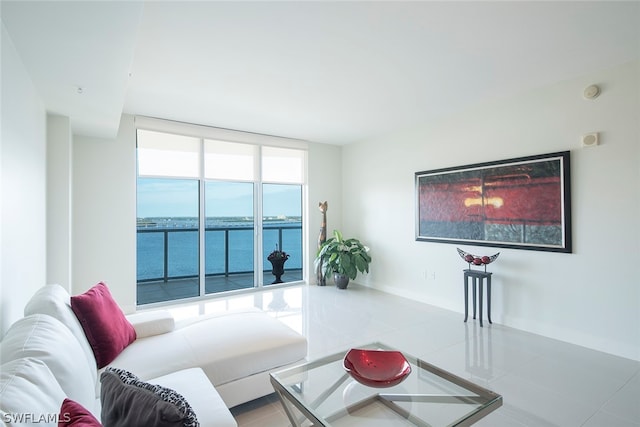 tiled living room featuring a water view and expansive windows