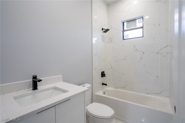 full bathroom with toilet, vanity, and tiled shower / bath