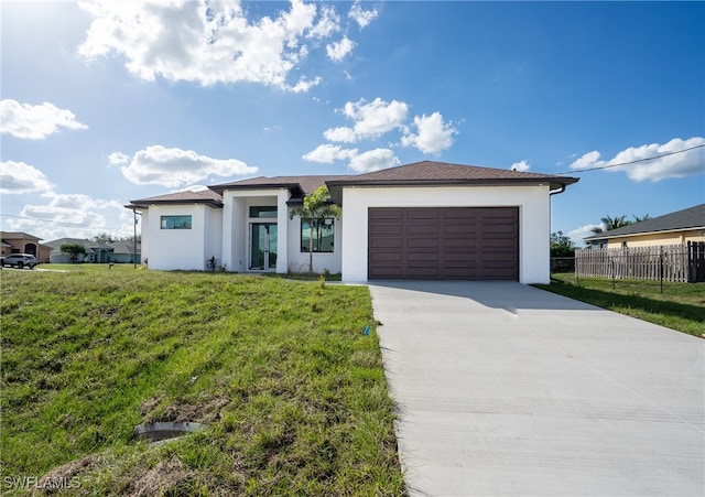 view of front of house with a front lawn and a garage