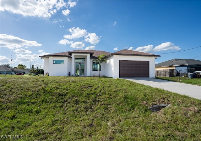 prairie-style house with a garage and a front yard