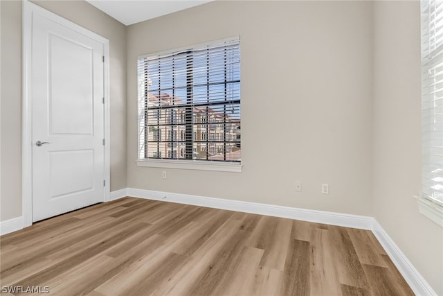 spare room with wood-type flooring