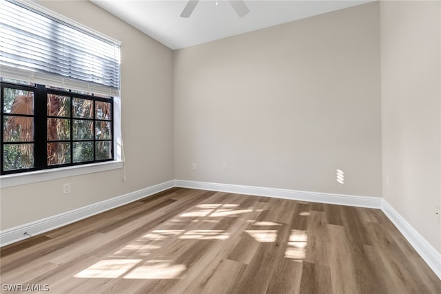 spare room with wood-type flooring and ceiling fan