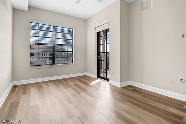 empty room featuring ceiling fan and hardwood / wood-style flooring