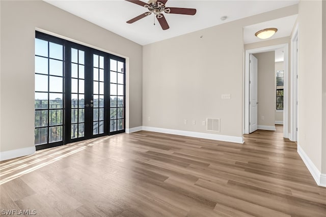 spare room with french doors, ceiling fan, and hardwood / wood-style floors