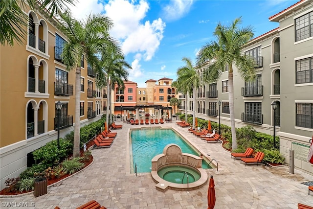 view of pool with a patio area and a community hot tub