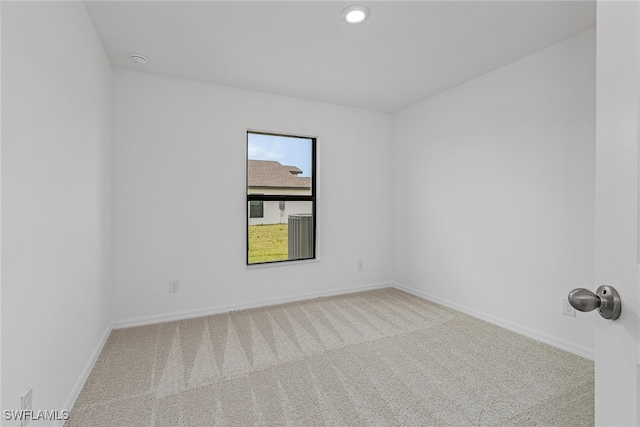 unfurnished room with light colored carpet