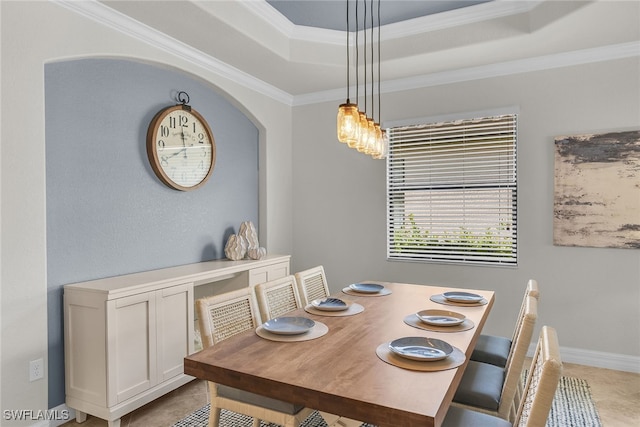 dining space with crown molding, a tray ceiling, and light tile patterned floors