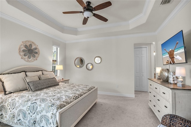 bedroom featuring crown molding, a raised ceiling, light carpet, and ceiling fan