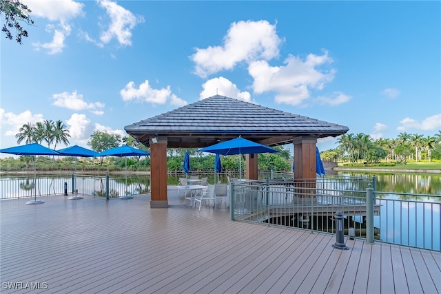 view of dock with a gazebo and a water view