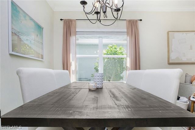 dining space with a notable chandelier and crown molding