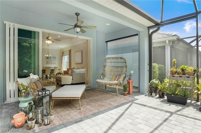 sunroom with ceiling fan with notable chandelier