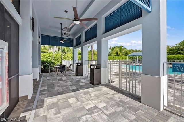 view of patio featuring ceiling fan and a fenced in pool