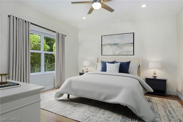 bedroom with hardwood / wood-style floors and ceiling fan