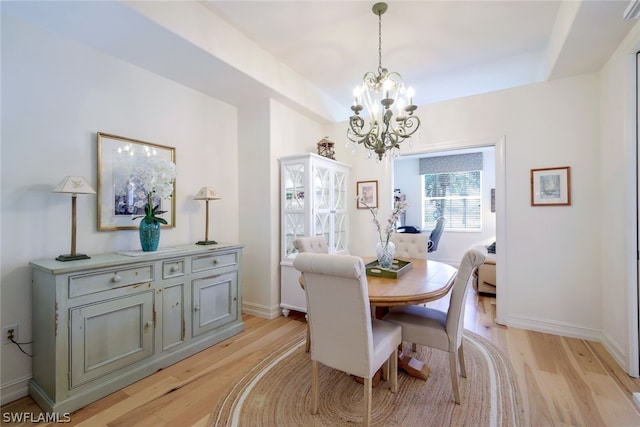 dining space featuring a chandelier and light hardwood / wood-style flooring