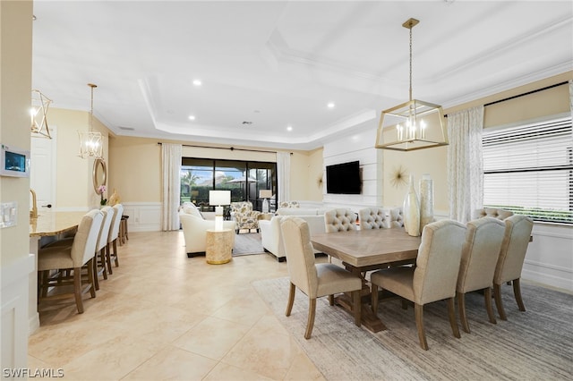 dining space featuring a tray ceiling and crown molding