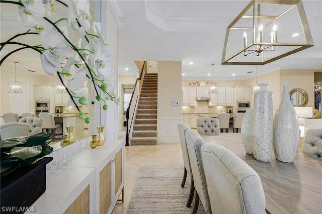 dining space featuring a raised ceiling and crown molding