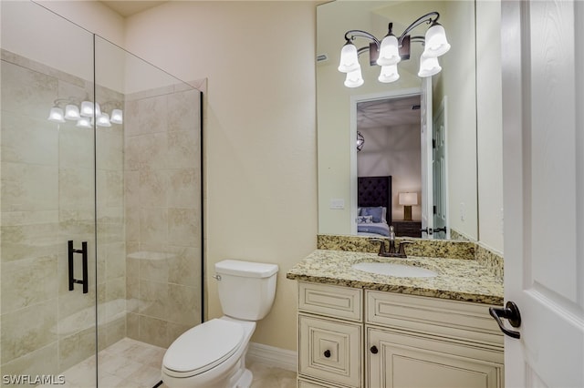 bathroom featuring tile patterned flooring, vanity, toilet, and a shower with shower door