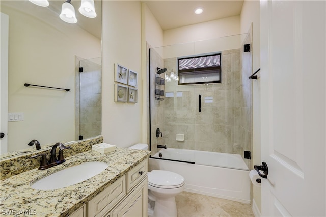 full bathroom featuring combined bath / shower with glass door, tile patterned floors, vanity, and toilet