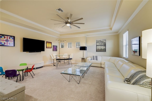 carpeted living room featuring ceiling fan, a raised ceiling, and ornamental molding