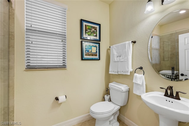 bathroom with sink, tile patterned flooring, and toilet