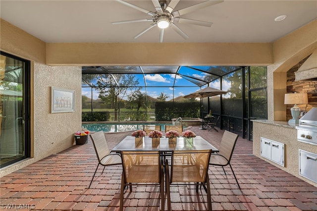 view of patio / terrace featuring a lanai, grilling area, and ceiling fan