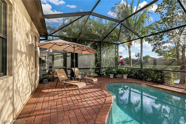 view of swimming pool featuring a patio and a lanai