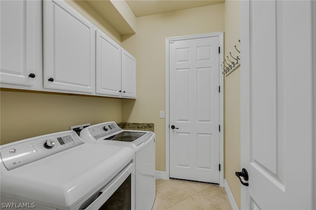 washroom featuring cabinets, separate washer and dryer, and light tile patterned flooring