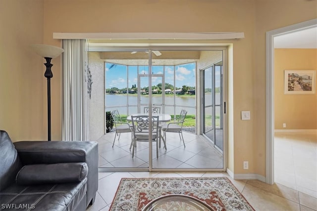 entryway featuring light tile floors and a water view