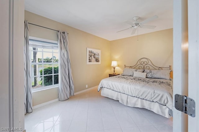 bedroom with ceiling fan and light tile floors