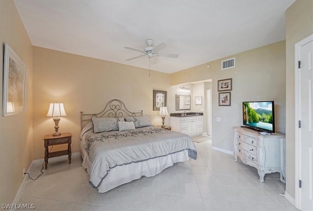 bedroom with sink, ceiling fan, light tile flooring, and ensuite bath