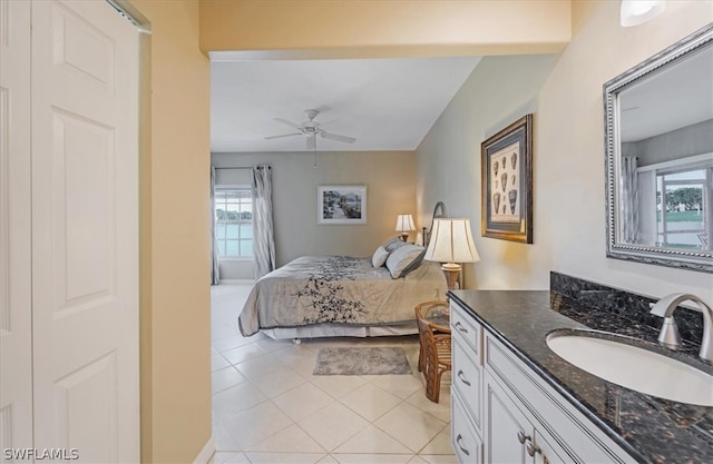 bedroom with sink, ceiling fan, and light tile floors