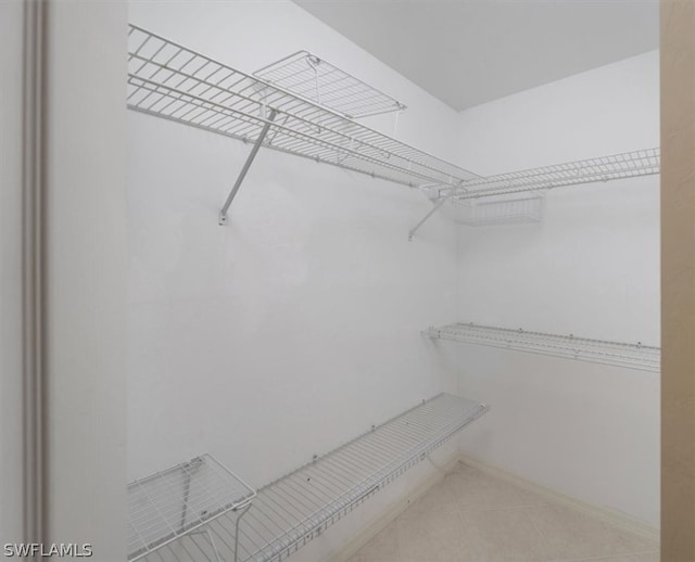 spacious closet with tile floors