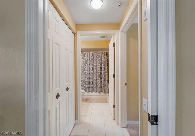 corridor with light tile floors