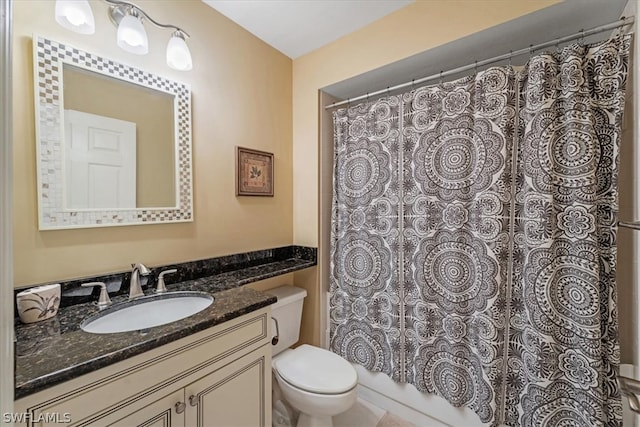 bathroom with toilet and large vanity