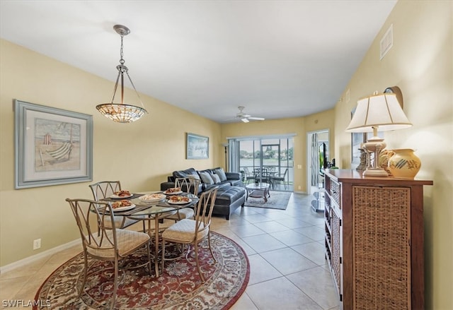 dining area with ceiling fan and light tile floors