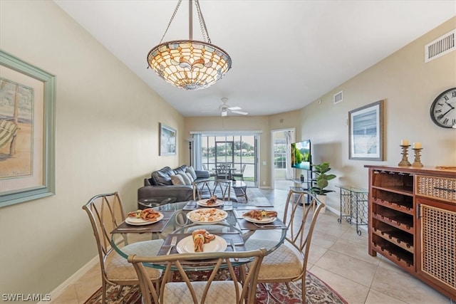 tiled dining space with ceiling fan