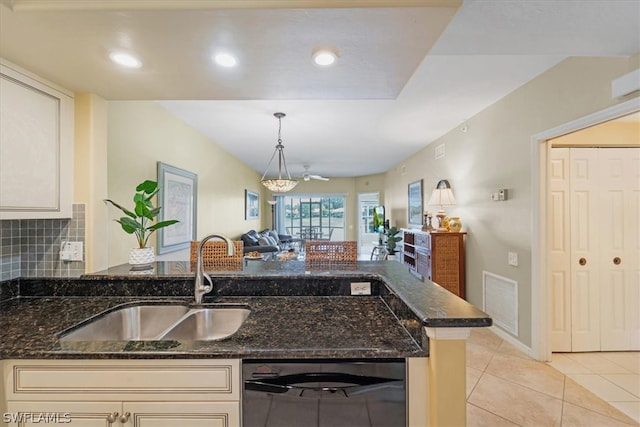 kitchen featuring backsplash, sink, light tile floors, stainless steel dishwasher, and dark stone counters