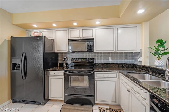 kitchen with backsplash, white cabinetry, light tile floors, and black appliances