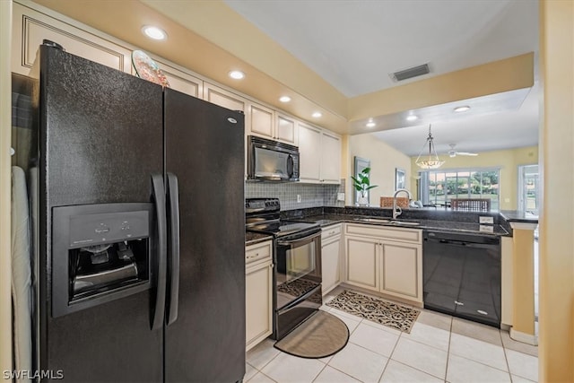 kitchen featuring hanging light fixtures, black appliances, tasteful backsplash, sink, and light tile floors