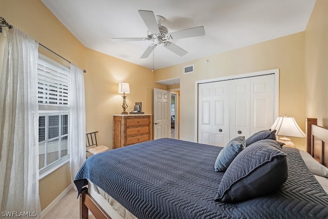 carpeted bedroom featuring a closet and ceiling fan