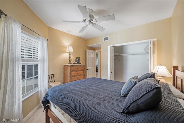 carpeted bedroom with a closet and ceiling fan