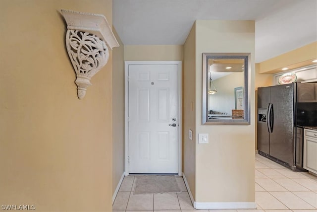 doorway with light tile floors