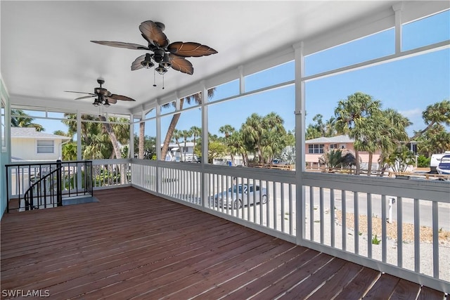 unfurnished sunroom featuring ceiling fan