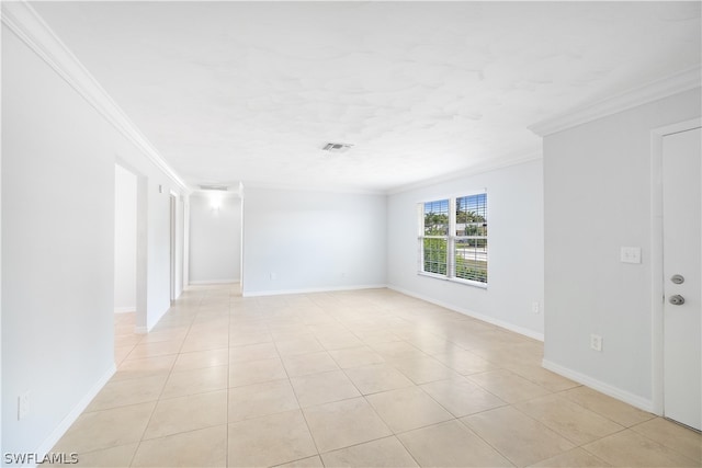 tiled empty room featuring ornamental molding