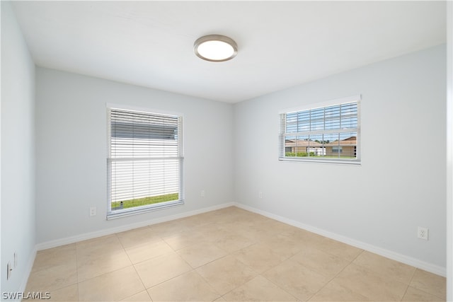 tiled spare room featuring a wealth of natural light